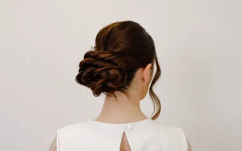 A low twisted bridal bun seen from behind