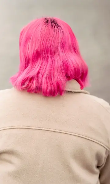 A bright pink bob seen from behind