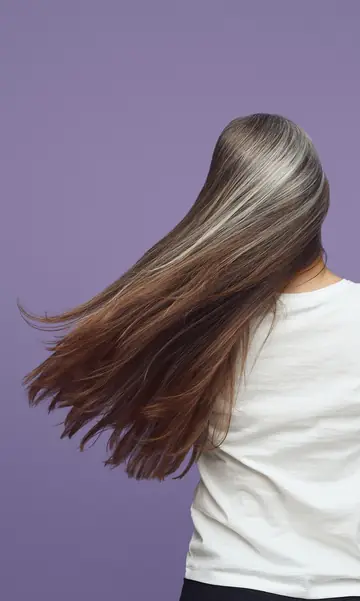 Long ash-grey hair swinging, seen from behind