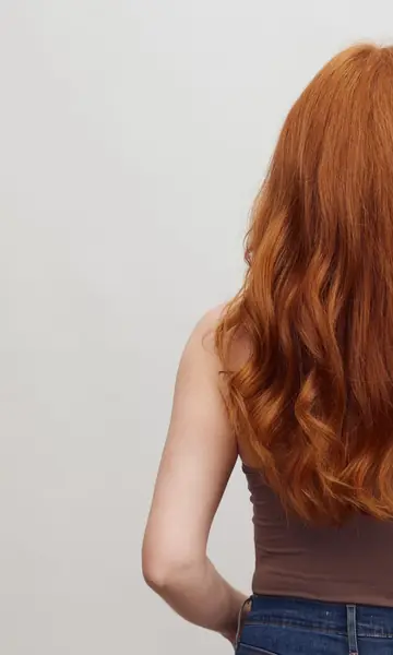 Long wavy copper hair seen from behind